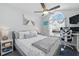Well-lit bedroom offers large sunny window, desk space, and comfortable bed with soft throw at 442 Troon Cir, Davenport, FL 33897