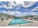 Bright community pool area featuring lounge chairs and clear blue water reflecting the sky at 442 Troon Cir, Davenport, FL 33897