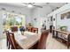 Dining room with tile flooring, decor, large dining table, and sliding door access to a screened-in lanai at 442 Troon Cir, Davenport, FL 33897