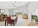 Bright dining room features a view of the pool and access to the screened-in lanai through a glass sliding door at 442 Troon Cir, Davenport, FL 33897