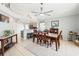 Dining room view shows tile floors, a large table, and access to the kitchen through a bar with stool seating at 442 Troon Cir, Davenport, FL 33897