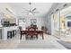Bright dining room features a ceiling fan, tile floors, a view of the screened lanai and an adjacent kitchen at 442 Troon Cir, Davenport, FL 33897