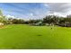 Well-manicured golf course with a clubhouse in the background on a sunny day at 442 Troon Cir, Davenport, FL 33897