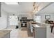 Modern kitchen featuring stainless steel appliances, gray cabinets, granite counters and tile flooring at 442 Troon Cir, Davenport, FL 33897
