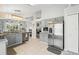 Spacious kitchen with gray cabinets, stainless steel appliances, granite counters, and an open view to the living areas at 442 Troon Cir, Davenport, FL 33897