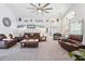 Open-concept living room with vaulted ceiling, modern decor, and plush leather sofas and chairs at 442 Troon Cir, Davenport, FL 33897
