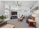 Cozy living room featuring vaulted ceilings, a modern fan, plush furniture, and ample natural light at 442 Troon Cir, Davenport, FL 33897
