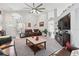 Comfortable living room featuring a ceiling fan, neutral carpet, and plush leather furniture at 442 Troon Cir, Davenport, FL 33897