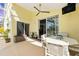 Screened patio with bright yellow walls, a fan and comfortable seating for outdoor living at 442 Troon Cir, Davenport, FL 33897