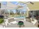 Relaxing pool area with screened enclosure, offers shaded seating and inviting blue water at 442 Troon Cir, Davenport, FL 33897