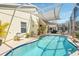 This screen-enclosed backyard pool allows you to enjoy swimming any time of day in this relaxing outdoor space at 442 Troon Cir, Davenport, FL 33897