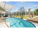 A screened-in pool is an ideal place to relax and enjoy the Florida sunshine year-round at 442 Troon Cir, Davenport, FL 33897