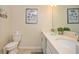 Bathroom with double sinks and a toilet, providing ample space and convenience at 4751 Clock Tower Dr # 203, Kissimmee, FL 34746