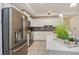 A well-lit kitchen features stainless steel appliances and light-colored cabinets with a gray backsplash at 4751 Clock Tower Dr # 203, Kissimmee, FL 34746