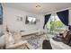 Open living room with plush seating, glass coffee tables, a TV, and sliding glass doors to the balcony at 4751 Clock Tower Dr # 203, Kissimmee, FL 34746