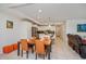 Open living and dining area with tile flooring, neutral decor, and a modern kitchen at 4751 Clock Tower Dr # 203, Kissimmee, FL 34746