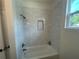 Bathroom tub/shower combo features white subway tile and a shower niche at 493 E Palmetto Ave, Longwood, FL 32750