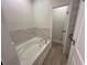 This bathroom has a beautifully tiled wall alongside a bathtub with new faucet hardware at 493 E Palmetto Ave, Longwood, FL 32750