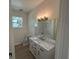 Bathroom with a marble-top vanity, modern lighting, and tile flooring at 493 E Palmetto Ave, Longwood, FL 32750