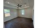 This bedroom features beautiful dark hardwood flooring and has a ceiling fan for added comfort at 493 E Palmetto Ave, Longwood, FL 32750