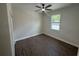 Bedroom with wood flooring, ceiling fan, and a bright window view at 493 E Palmetto Ave, Longwood, FL 32750