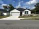 Charming single-story home with a well-manicured lawn and a concrete driveway at 493 E Palmetto Ave, Longwood, FL 32750