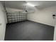 A clean and empty garage with an automatic garage door and gray epoxy-coated floors at 493 E Palmetto Ave, Longwood, FL 32750