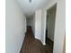 Long hallway with wood-look flooring and neutral paint, bright and inviting at 493 E Palmetto Ave, Longwood, FL 32750