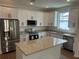 Modern kitchen features stainless appliances, granite countertops, and island at 493 E Palmetto Ave, Longwood, FL 32750