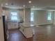 Bright kitchen with island, stainless steel appliances, and granite countertops at 493 E Palmetto Ave, Longwood, FL 32750