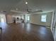 Open-concept living room with wood floors, recessed lighting, and kitchen view at 493 E Palmetto Ave, Longwood, FL 32750