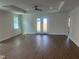 Bright living room features a trey ceiling, wood floors, and French doors at 493 E Palmetto Ave, Longwood, FL 32750