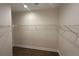 A walk-in closet with hardwood flooring and shelving for organization and ample storage at 493 E Palmetto Ave, Longwood, FL 32750