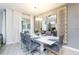 Elegant dining area with a modern table setting, stylish lighting, and sleek gray chairs at 4962 Windermere Ave, Kissimmee, FL 34746