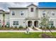 Inviting townhome with a well-maintained lawn and charming architectural details at 4962 Windermere Ave, Kissimmee, FL 34746