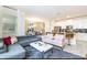 Open-concept living space with modern furniture, connecting the living room to the kitchen and dining area at 4962 Windermere Ave, Kissimmee, FL 34746