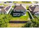 Aerial view of the property with a well-maintained lawn and a fenced backyard at 5456 Crepe Myrtle Cir, Kissimmee, FL 34758