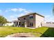 Large backyard featuring an enclosed sunroom, a well-kept lawn, and a fenced perimeter at 5456 Crepe Myrtle Cir, Kissimmee, FL 34758