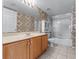 Bathroom with decorative wallpaper, vanity, and shower-tub combination at 5456 Crepe Myrtle Cir, Kissimmee, FL 34758