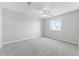Cozy bedroom features neutral carpet, a window, and ample natural light at 5456 Crepe Myrtle Cir, Kissimmee, FL 34758