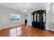 Dining room with hardwood floors, chandelier lighting, and view of the backyard at 5456 Crepe Myrtle Cir, Kissimmee, FL 34758