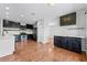 Updated kitchen featuring black cabinets, stainless steel appliances, and hardwood floors at 5456 Crepe Myrtle Cir, Kissimmee, FL 34758