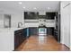 Remodeled kitchen with black cabinets, stainless steel appliances, and a center island at 5456 Crepe Myrtle Cir, Kissimmee, FL 34758