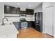 Modern kitchen with black cabinets, stainless steel appliances, and white countertops at 5456 Crepe Myrtle Cir, Kissimmee, FL 34758