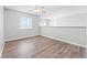 Bright living room boasts wood floors, a ceiling fan, and natural light from a large window at 5456 Crepe Myrtle Cir, Kissimmee, FL 34758