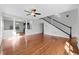 Bright living room with hardwood floors, decorative columns, and a staircase at 5456 Crepe Myrtle Cir, Kissimmee, FL 34758
