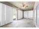 Enclosed sun room with sliding doors and vertical blinds offers a versatile living space at 5456 Crepe Myrtle Cir, Kissimmee, FL 34758