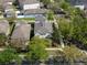 An aerial shot of a house with mature trees in a community with a street at 6475 New Independence Pkwy, Winter Garden, FL 34787