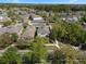 An aerial view shows a residential neighborhood with tree-lined streets and well-maintained homes and lawns at 6475 New Independence Pkwy, Winter Garden, FL 34787