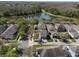 An aerial view of a home near a lake and surrounded by lush trees and neighborhood homes at 6475 New Independence Pkwy, Winter Garden, FL 34787